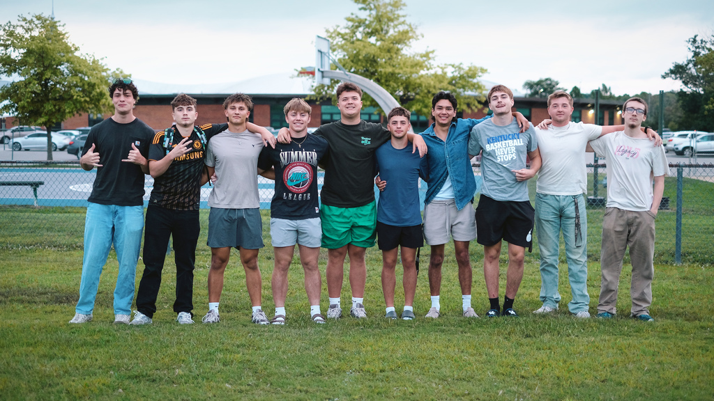 Seniors pose for a photo in front of their school