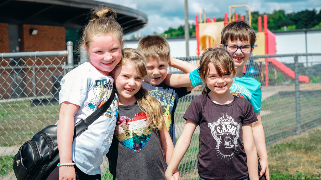 Elementary students posing for a photo on the playground