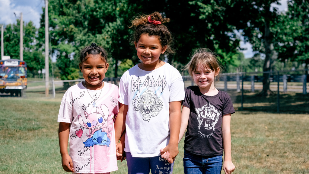 Elementary students pose for a photo on playground