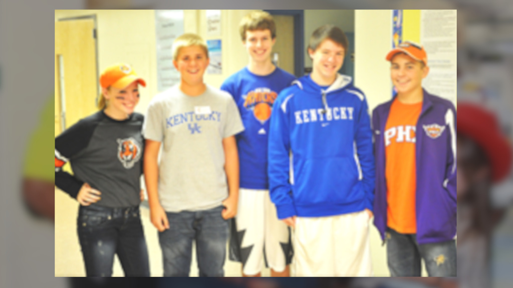 Students wearing their favorite sports teams pose of r photo