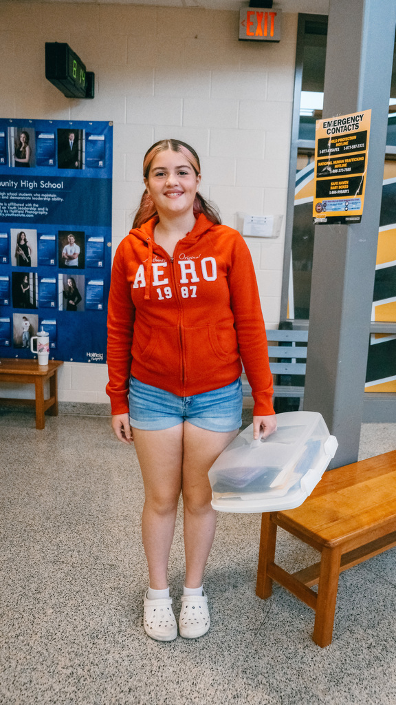 Student holding a cake carrier
