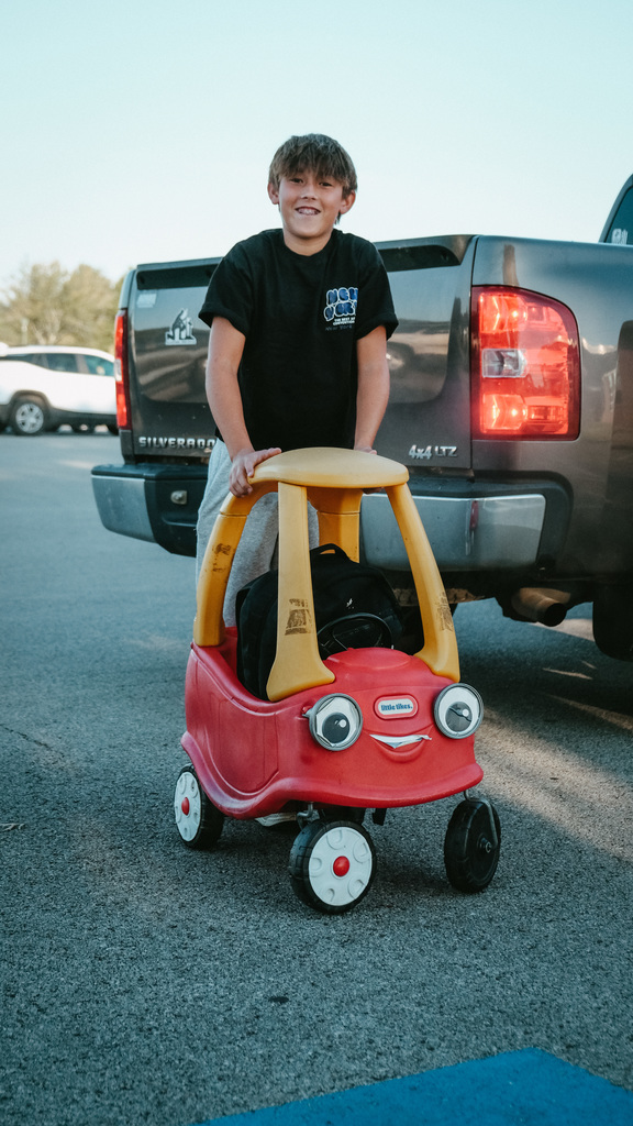 Student posing with a cart on Anything But a Backpack Day