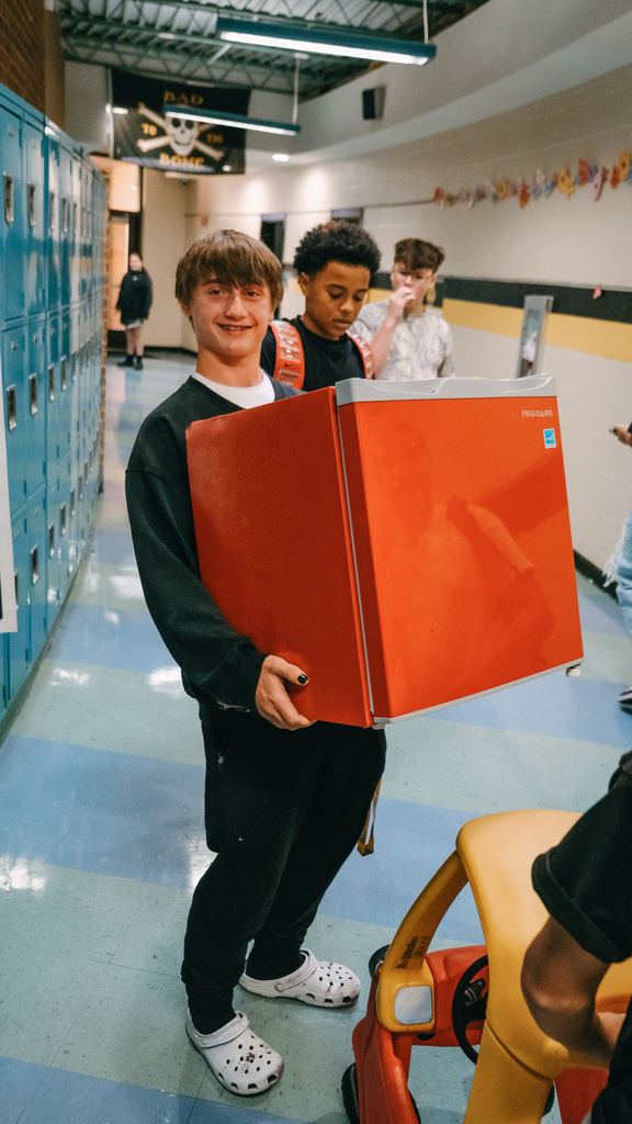 Student holding a mini fridge