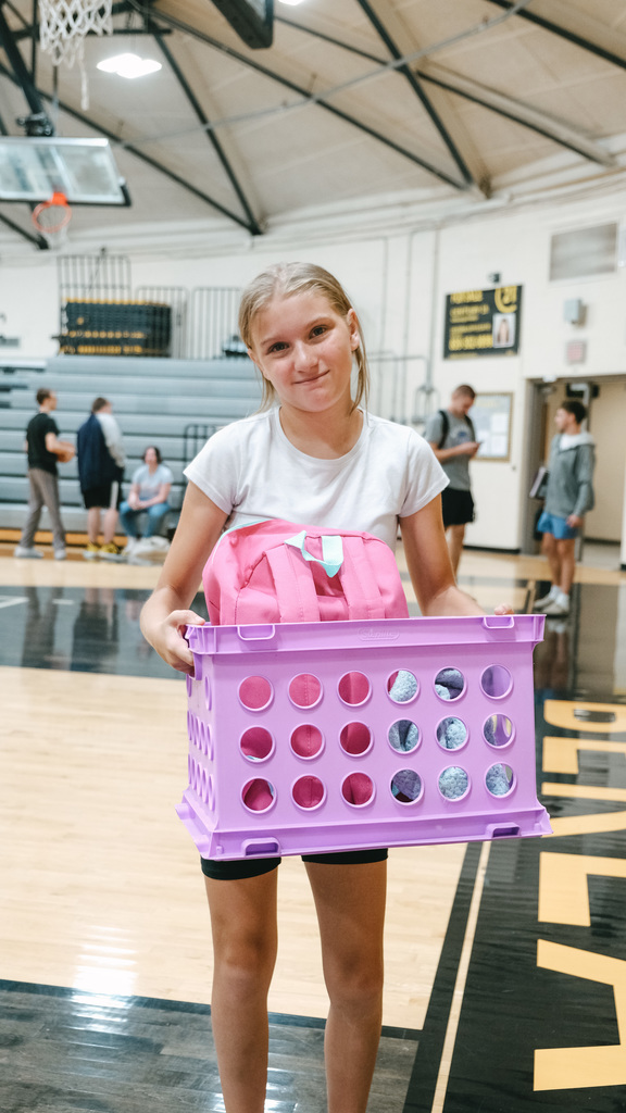Student holding a crate