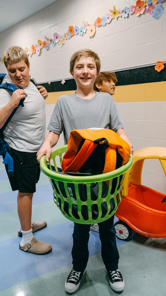Student holding a laundry basket