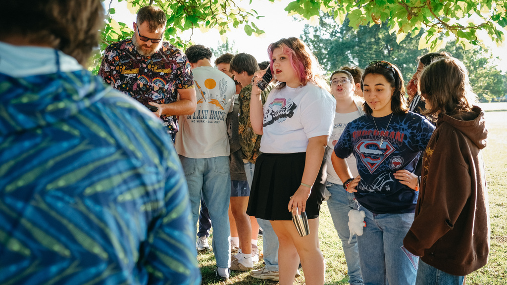 High school students standing around a tree