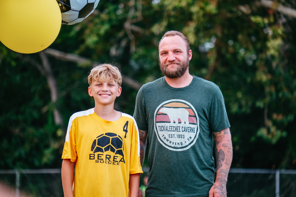 8th grader poses for photo with parent
