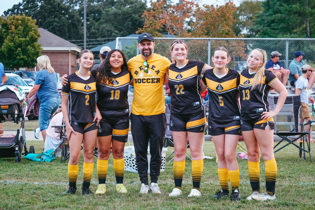 8th grade soccer athletes pose for a photo