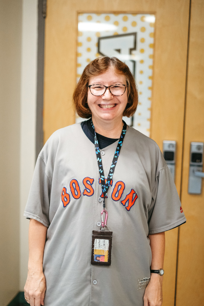 Teacher poses for photo wearing Jersey