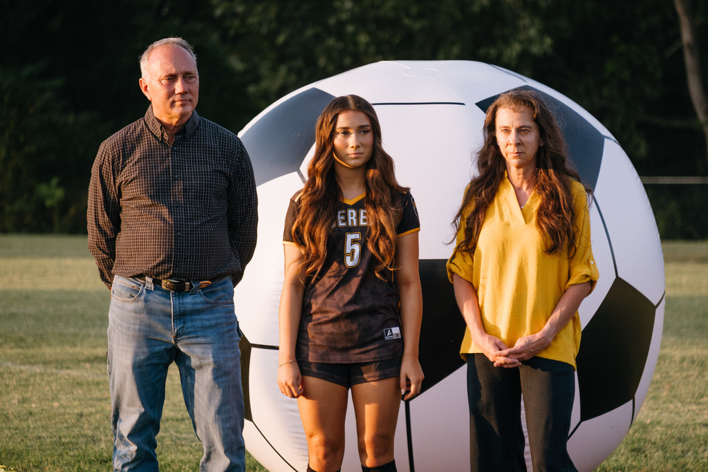 Student Athletes Pose for Photos with their Families During HS Girls Soccer Senior Night