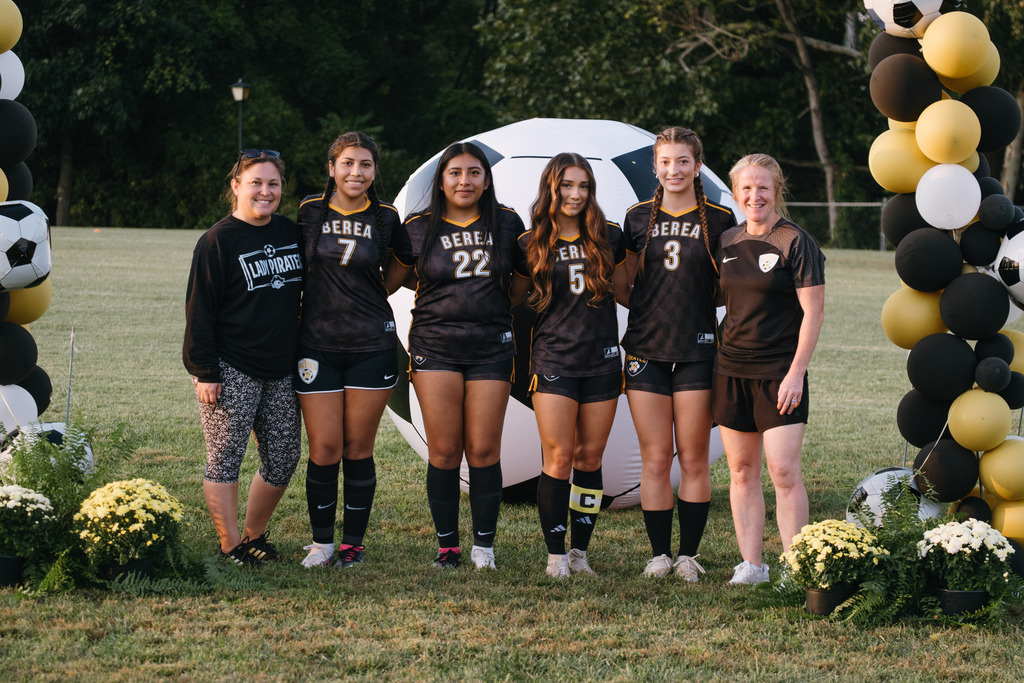 Student Athletes Pose for Photos with their Families During HS Girls Soccer Senior Night