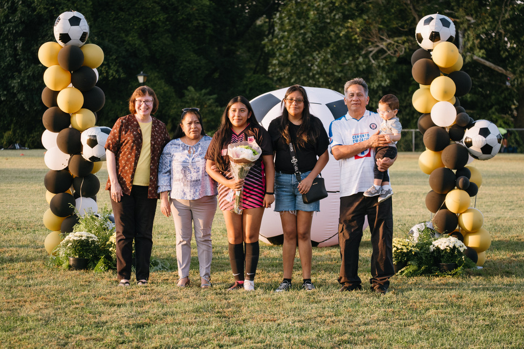 Student Athletes Pose for Photos with their Families During HS Girls Soccer Senior Night