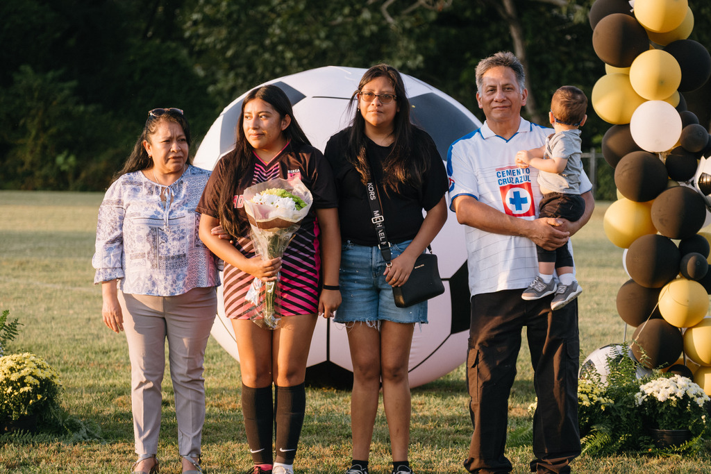 Student Athletes Pose for Photos with their Families During HS Girls Soccer Senior Night