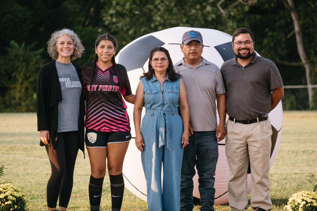 Student Athletes Pose for Photos with their Families During HS Girls Soccer Senior Night