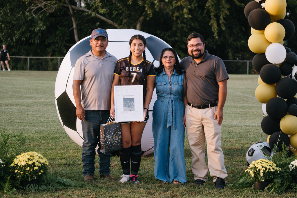 Student Athletes Pose for Photos with their Families During HS Girls Soccer Senior Night