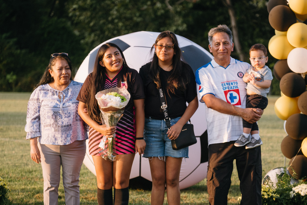 Student Athletes Pose for Photos with their Families During HS Girls Soccer Senior Night