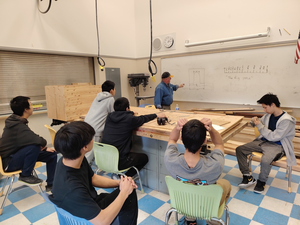 Taking notes on construction in Teller AK with instructor mark