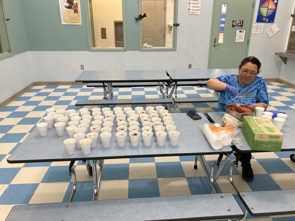 Ms. Cora preparing eskimo ice cream for Teller Alaska Indigenous Peoples Day 