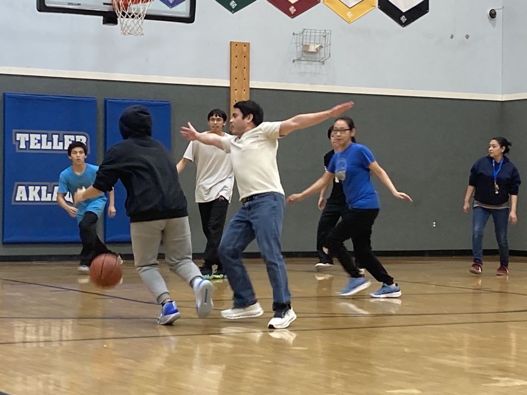 Randy playing defense having fun playing student vs staff basketball game