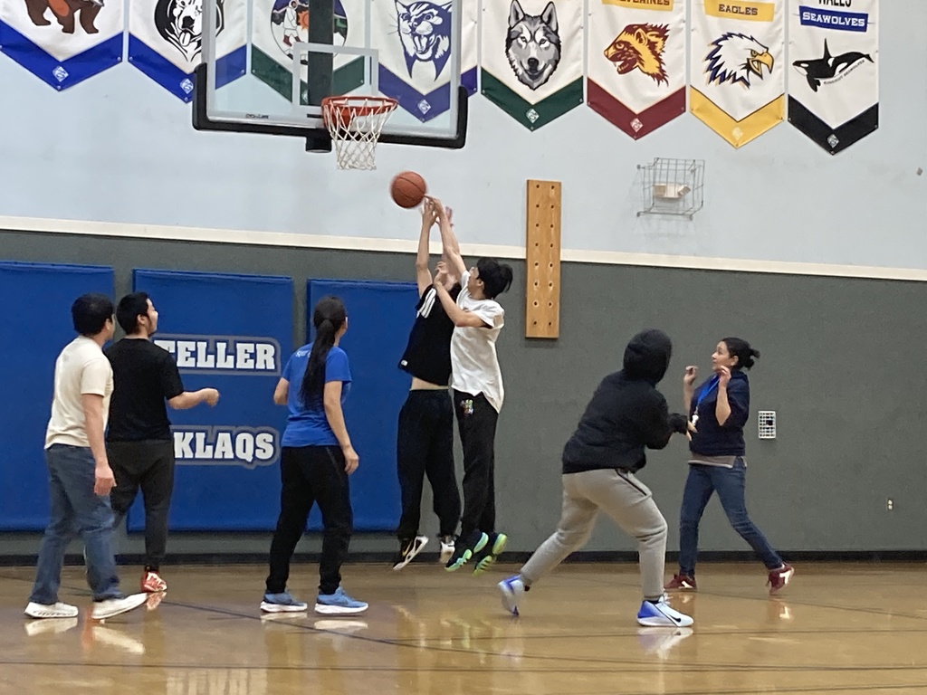 having fun playing student vs staff basketball game rebounding