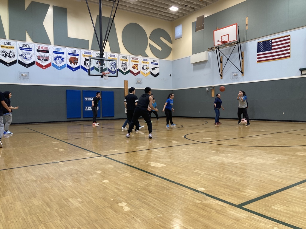 having fun playing student vs staff basketball game passing around