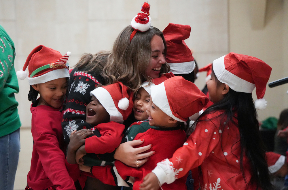 students hugging teacher