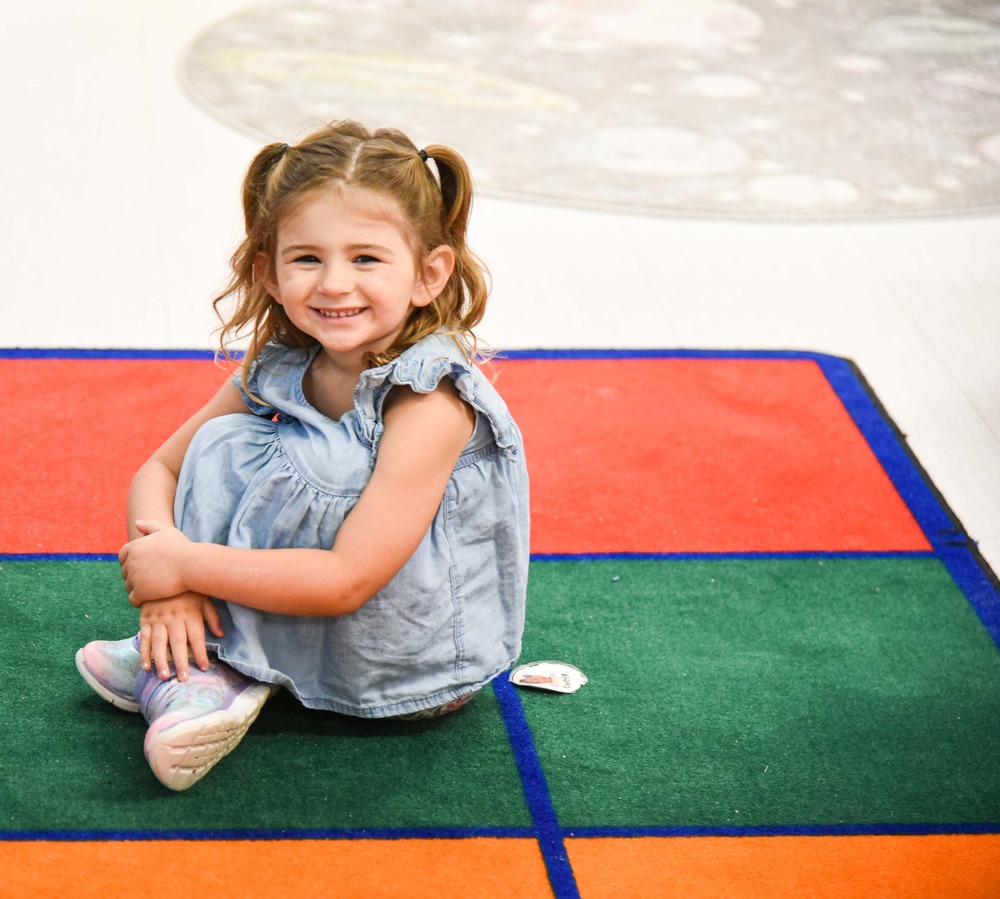 student sitting on carpet