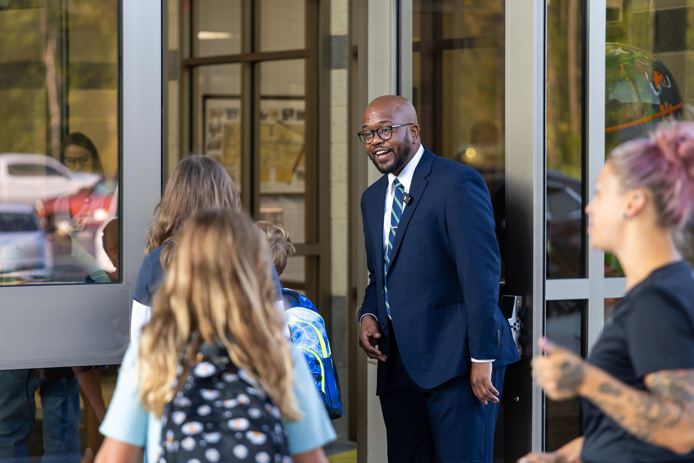 Dr. Dixon holds doors open for students