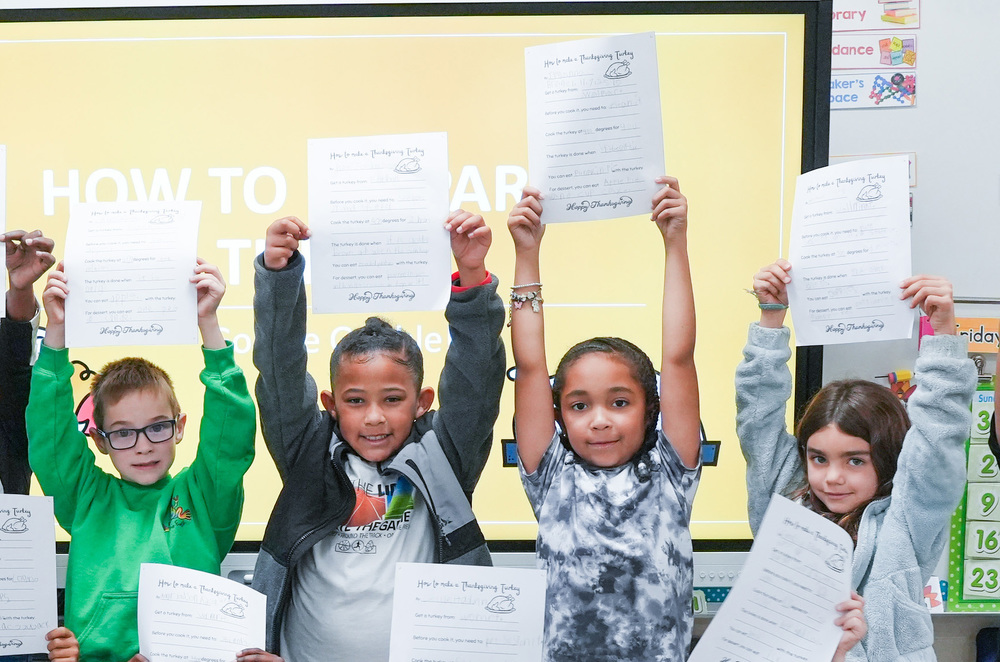 students holding up claswork