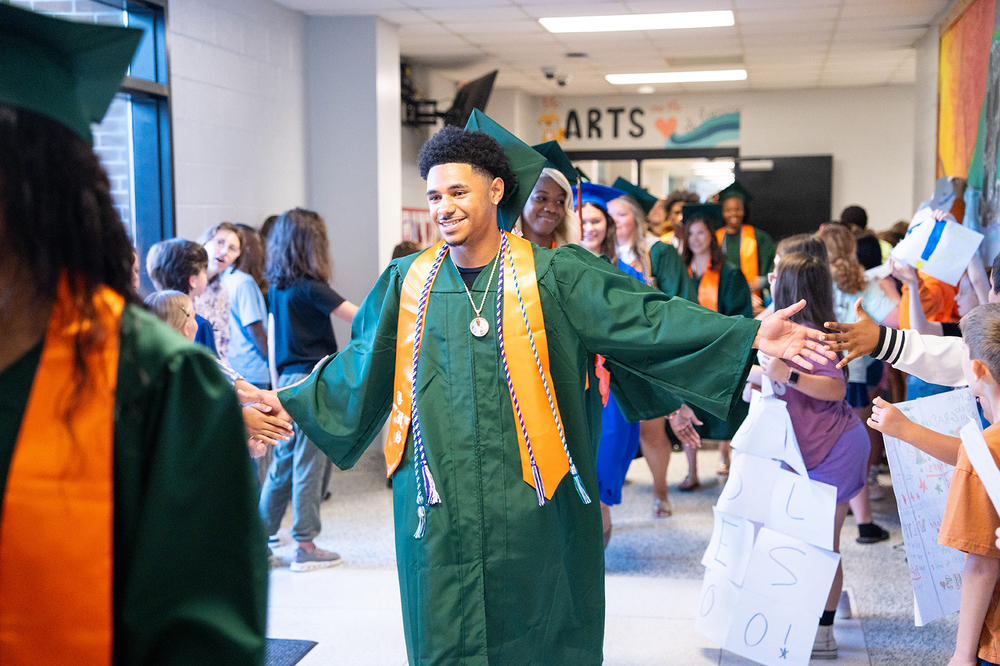 Timberland High student  high fiving elementary school students