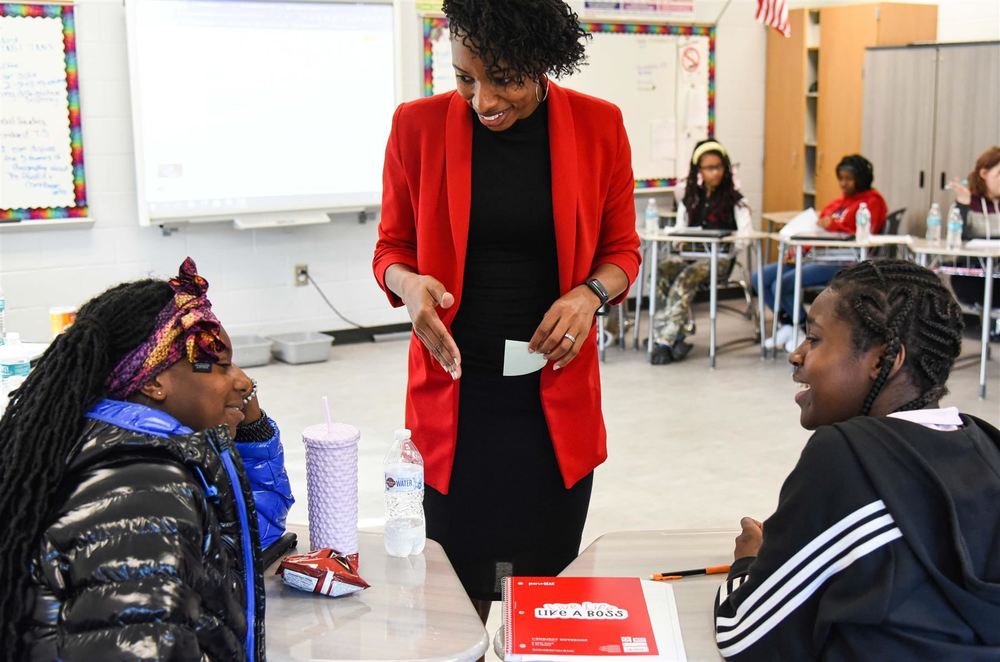 Teacher speaking with students