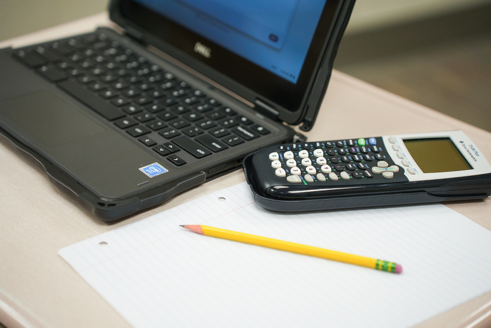 generic photo of chromebook, calculator and pencil