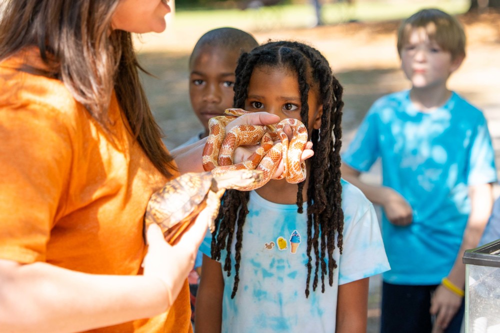 students eyes peaking over a snake
