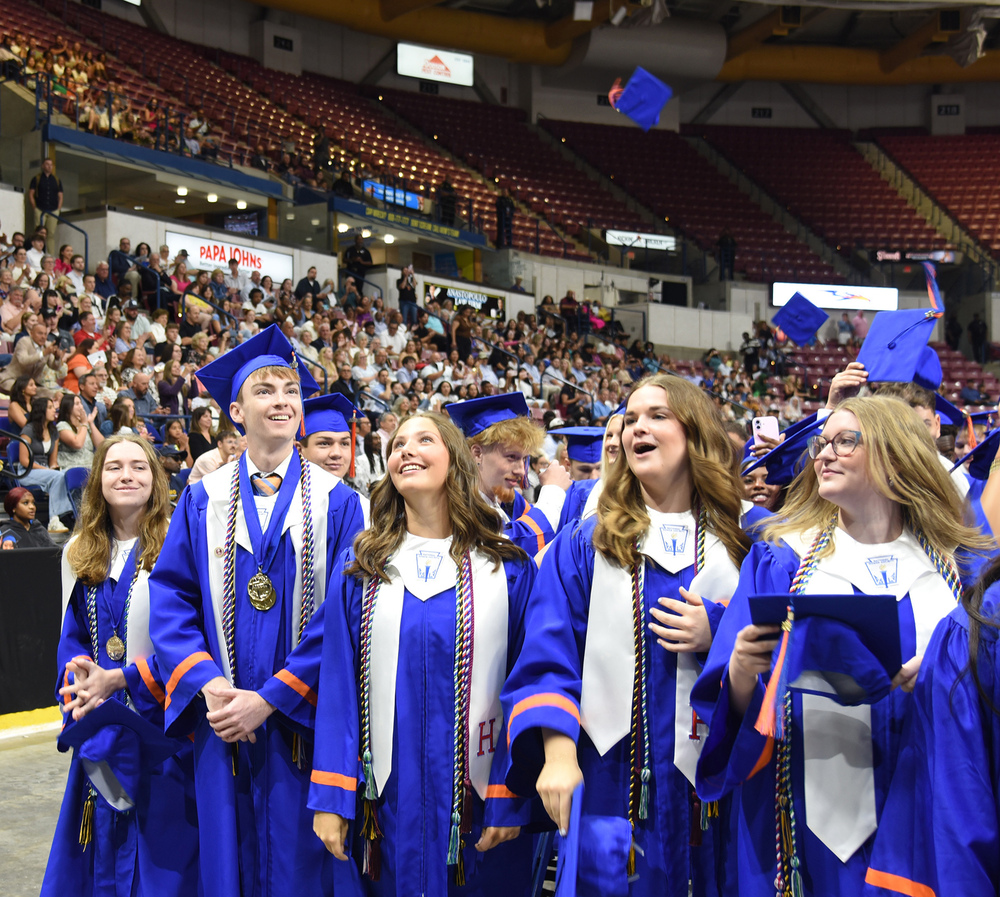students tossing caps 
