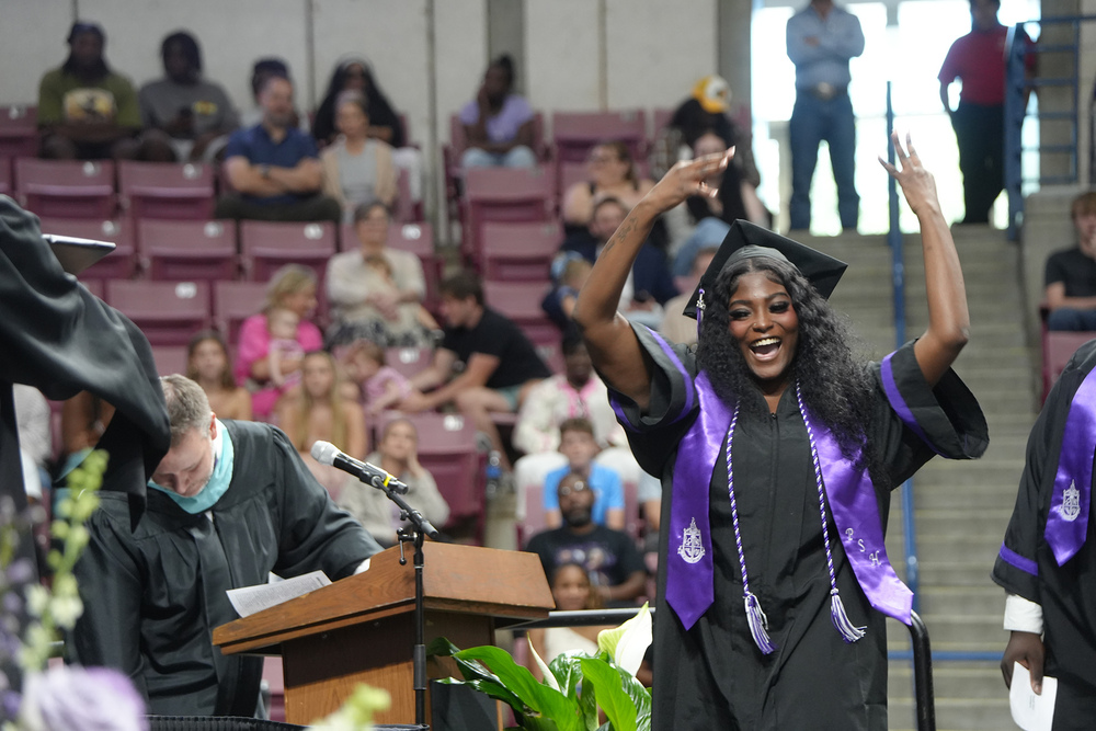 girl going across stage