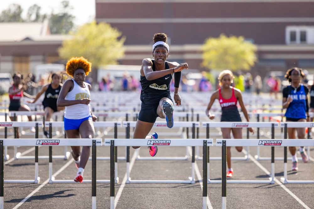 Goose Creek High Track Star jumping hurdles