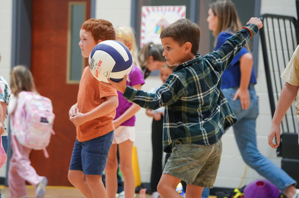 boy serving volleyball