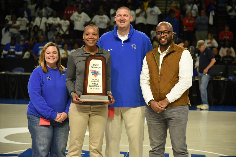 Coach Crystal Peace with state championship trophy
