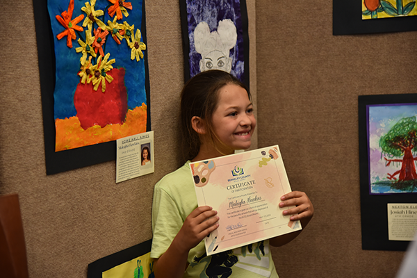 Student holding certificate