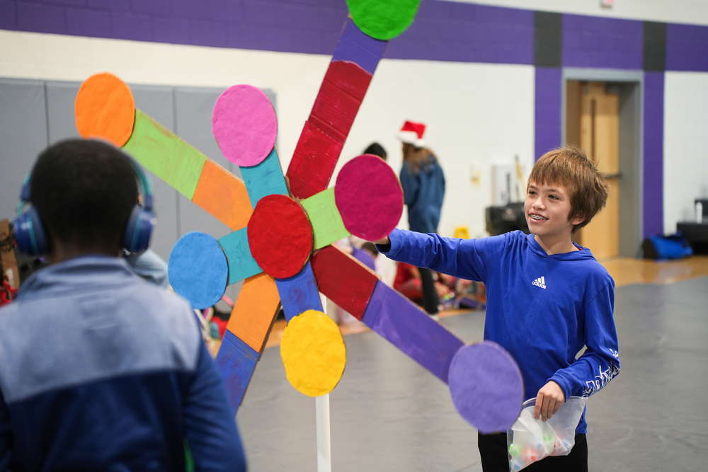 child with cardboard mechanism