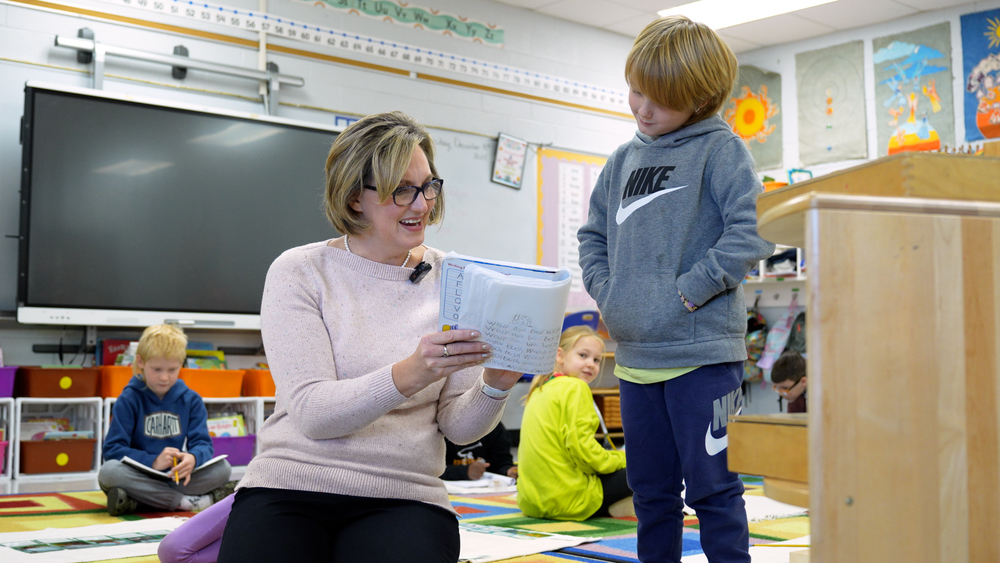teacher helping student