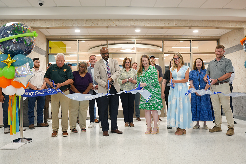 district and government officials cutting ribbon on Midtown Middle