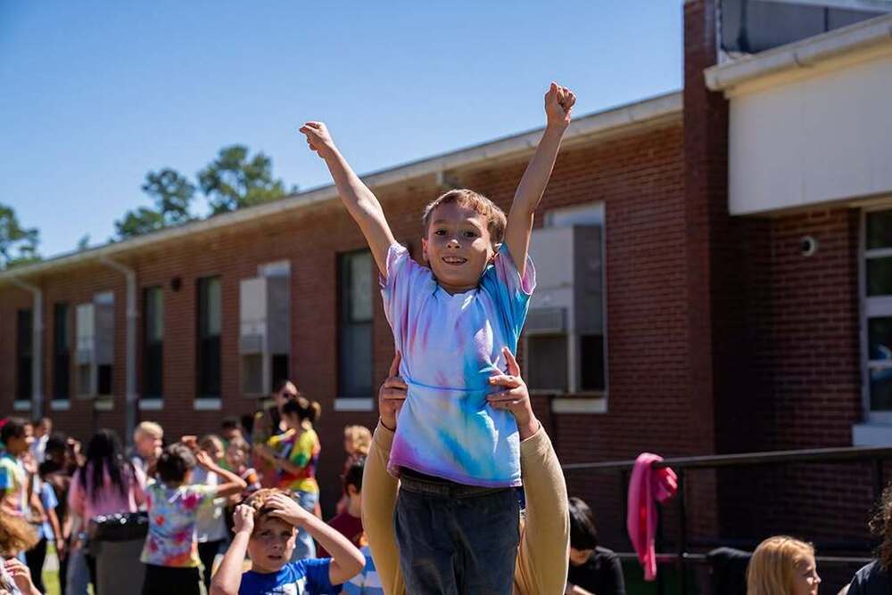 student high fiving other students