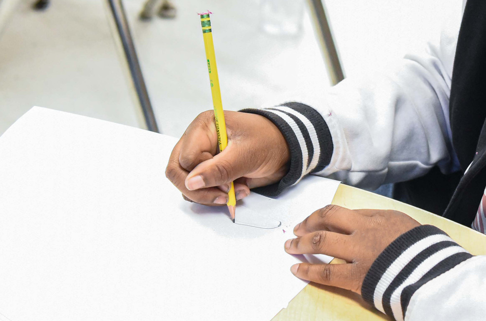 students hands writing