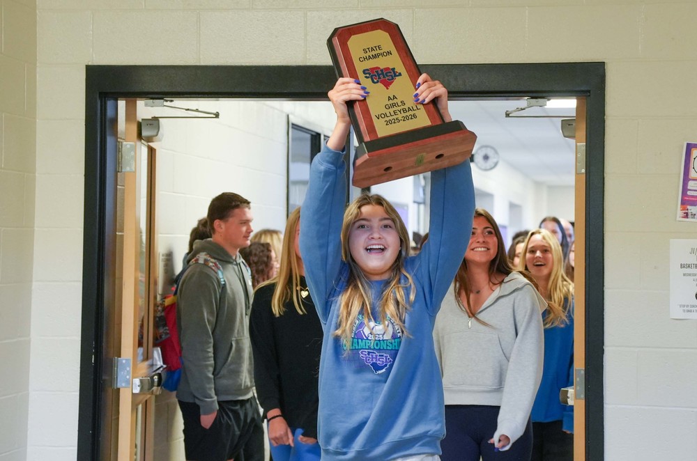 volleyball student with trophy