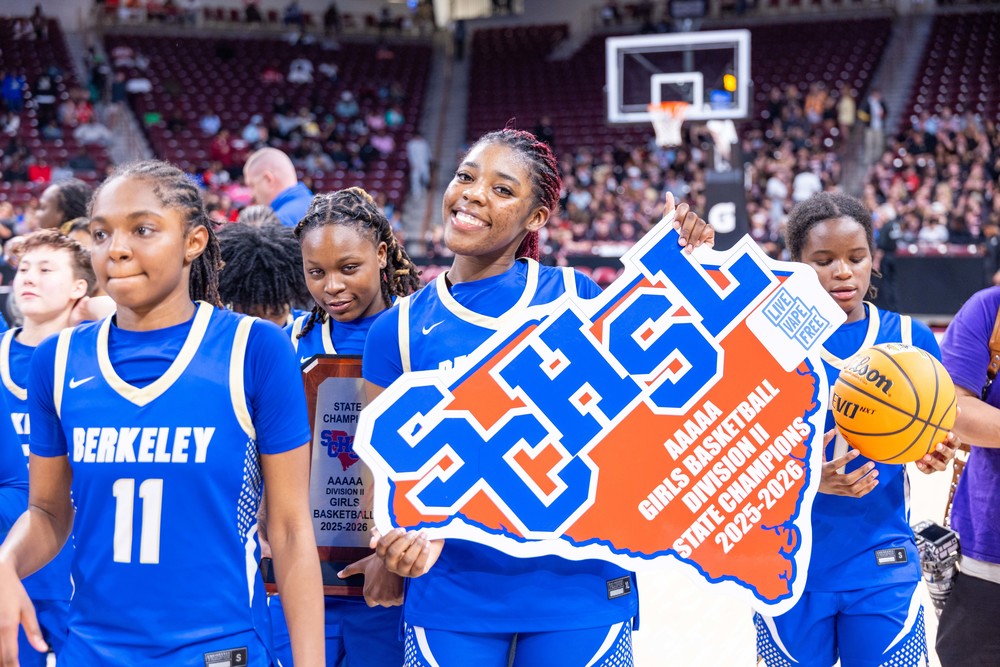 BHS  girls basketball with state title sign