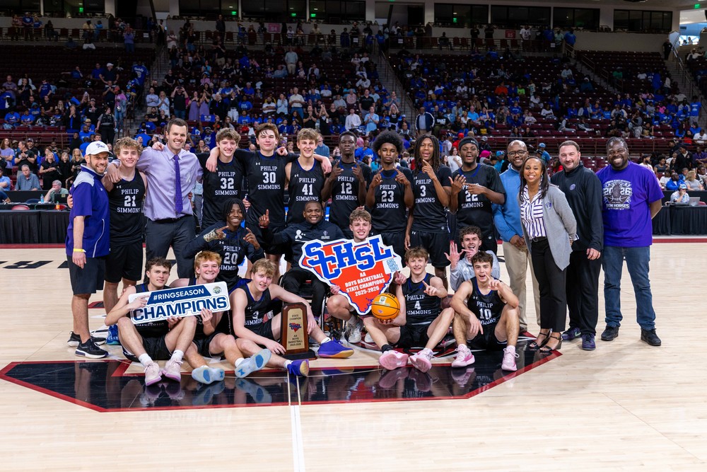 PSH boys basketball team with state title trophy and sign