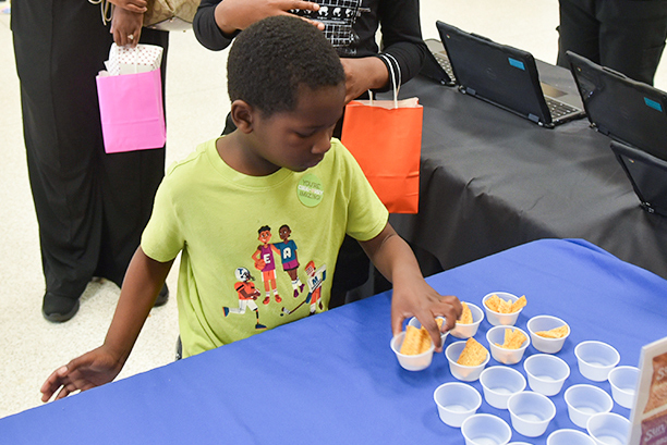 child sampling food at 2025 event