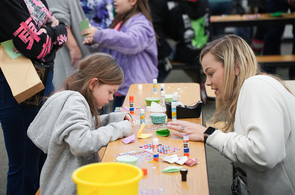 child with staff member and parent