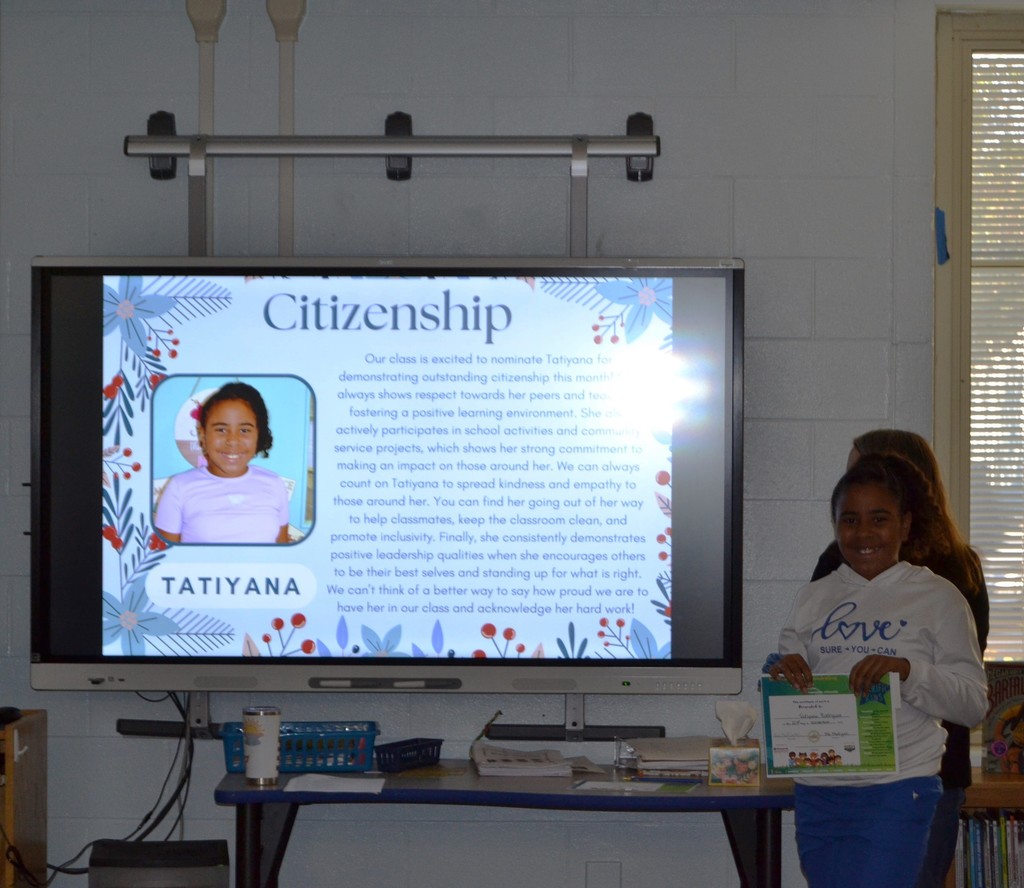 Student receiving student of the month award